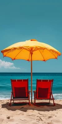 Beach chairs under a yellow umbrella